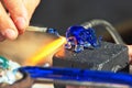 The Artist-glass blower produces a tiny figure of an elephant